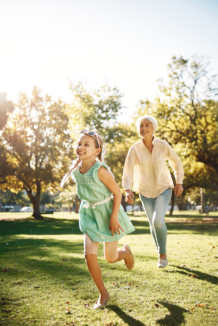 An older couple walking through a park